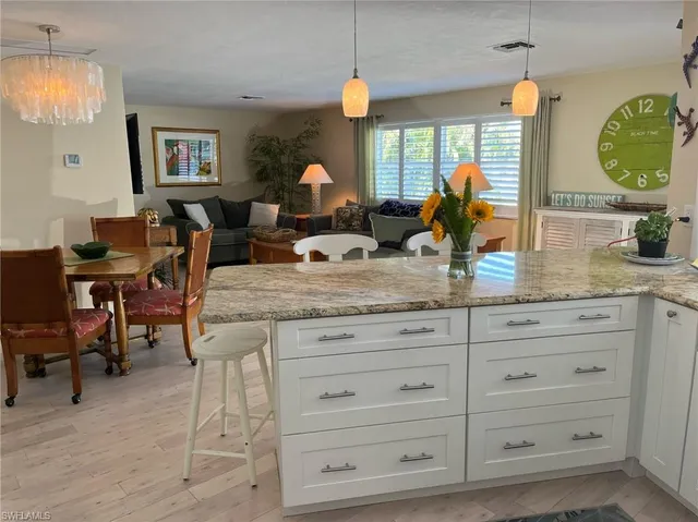 a kitchen with cabinets appliances and a wooden floor