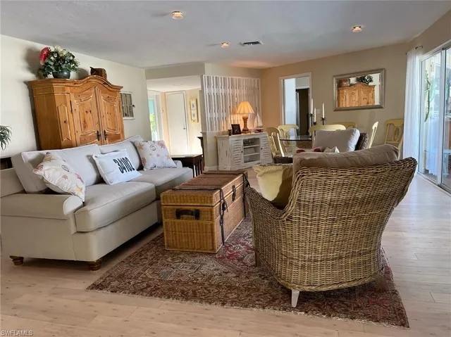 a living room with furniture a couch and dresser