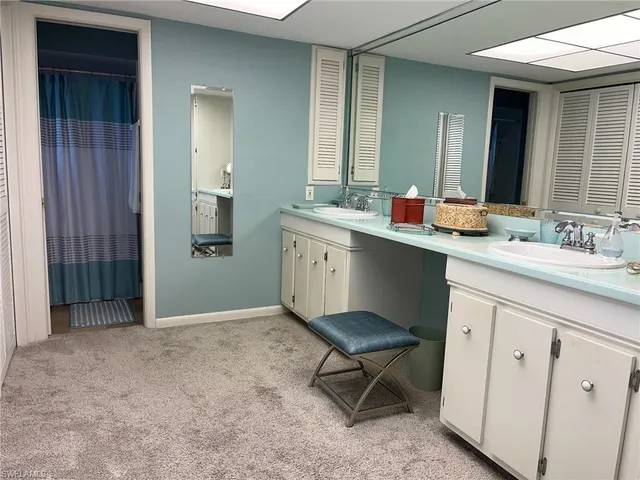 a spacious bathroom with a sink a toilet a mirror and vanity