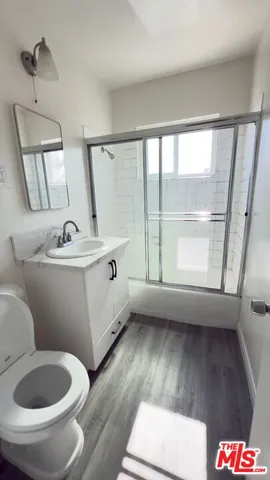 a bathroom with a sink toilet and a mirror