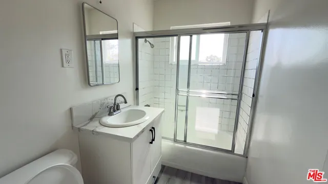 a kitchen with granite countertop a stove a sink and a window