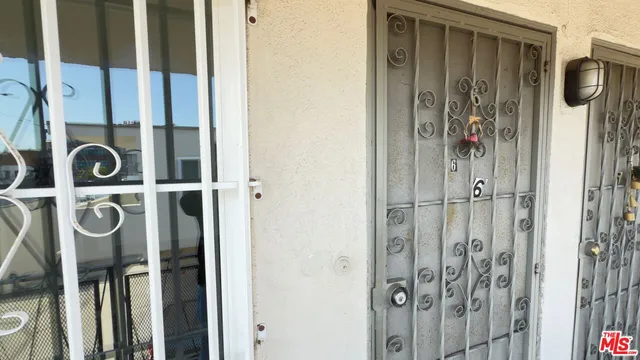 a view of a kitchen with a sink and dishwasher a stove top oven with wooden floor