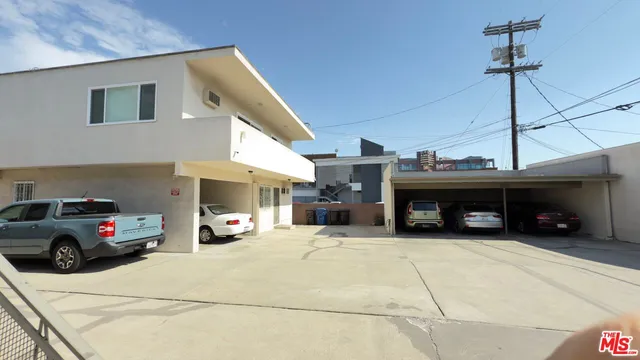 a view of a big room with wooden floor and windows