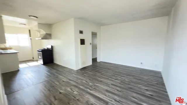 a view of a kitchen with wooden floor and a sink