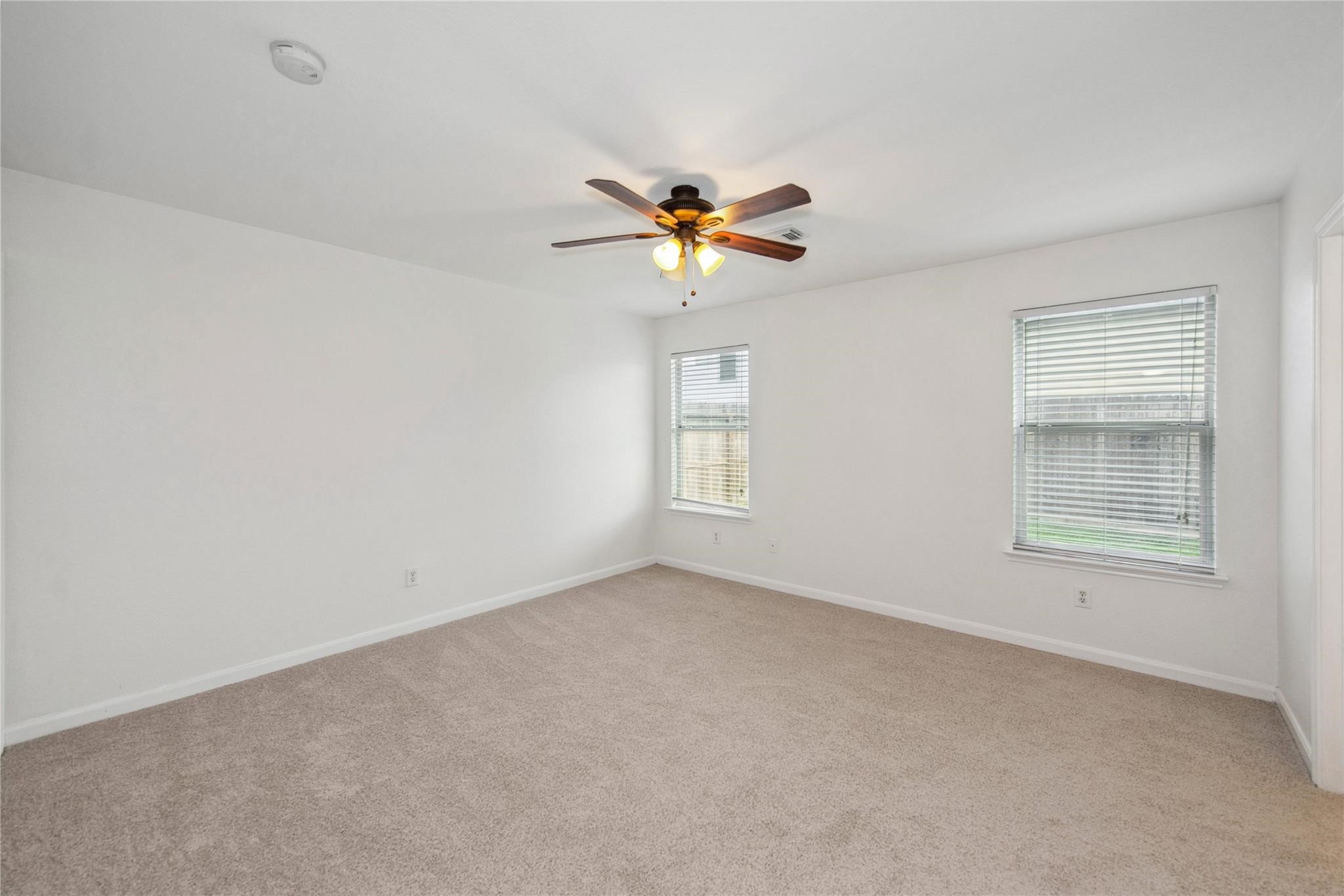 16310 Chandler Ridge Lane Cypress, TX 77429 - Photo 12 of 25 an empty room with a window and a fan