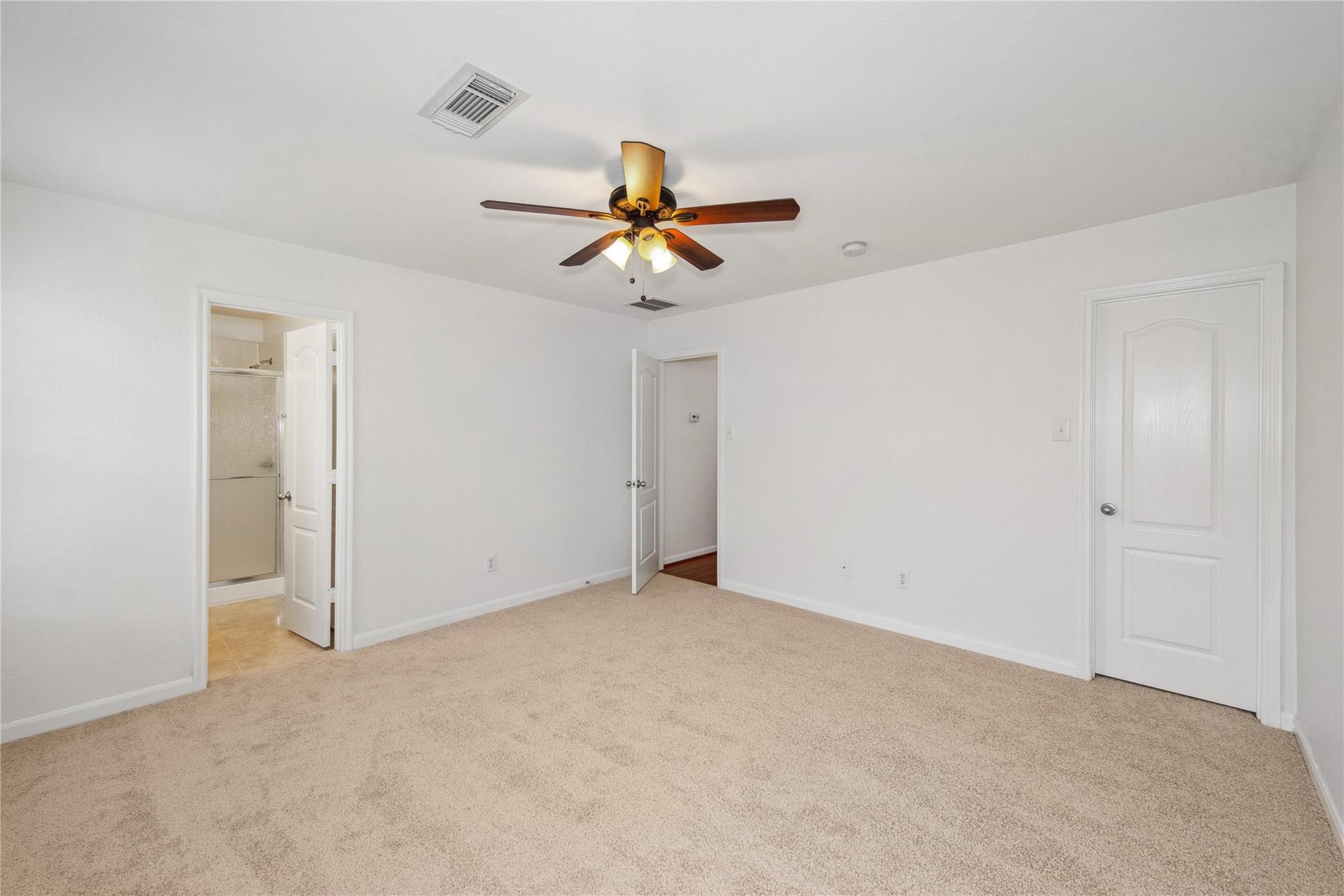 16310 Chandler Ridge Lane Cypress, TX 77429 - Photo 13 of 25 an empty room with closet and chandelier fan