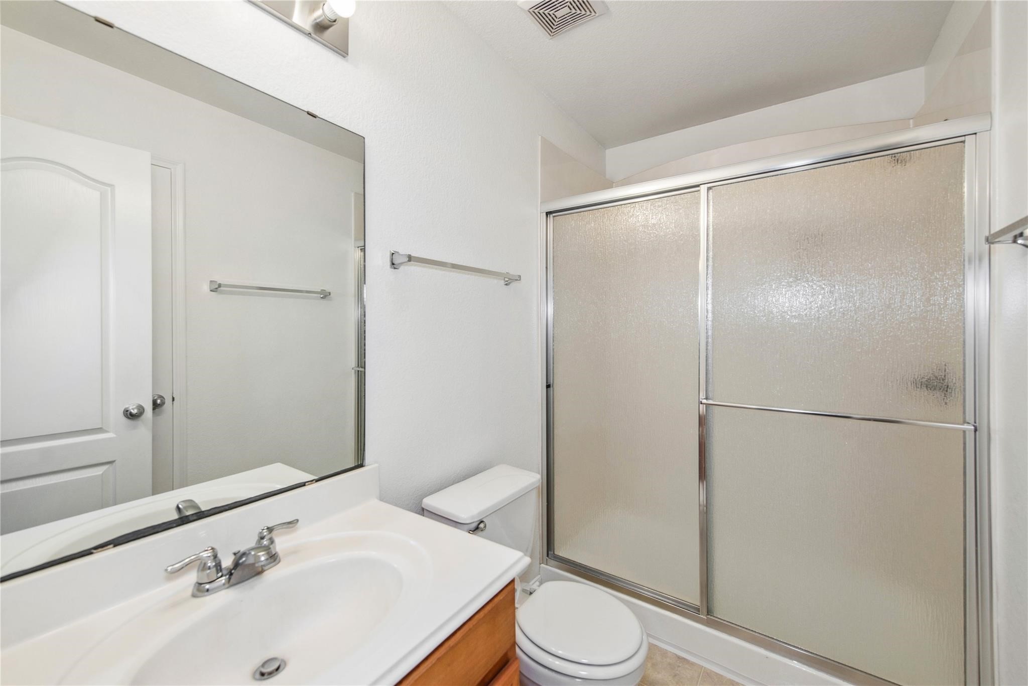 16310 Chandler Ridge Lane Cypress, TX 77429 - Photo 14 of 25 a bathroom with a sink toilet and shower