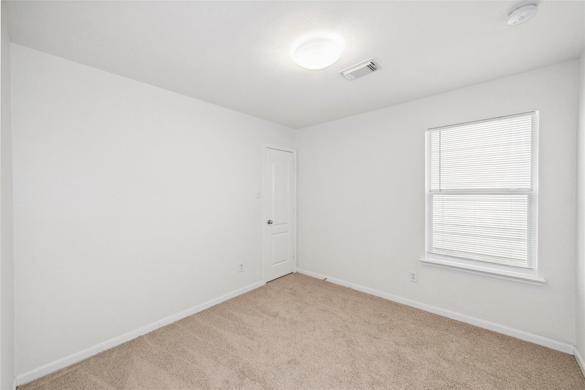 16310 Chandler Ridge Lane Cypress, TX 77429 - Photo 15 of 25 an empty room with a window