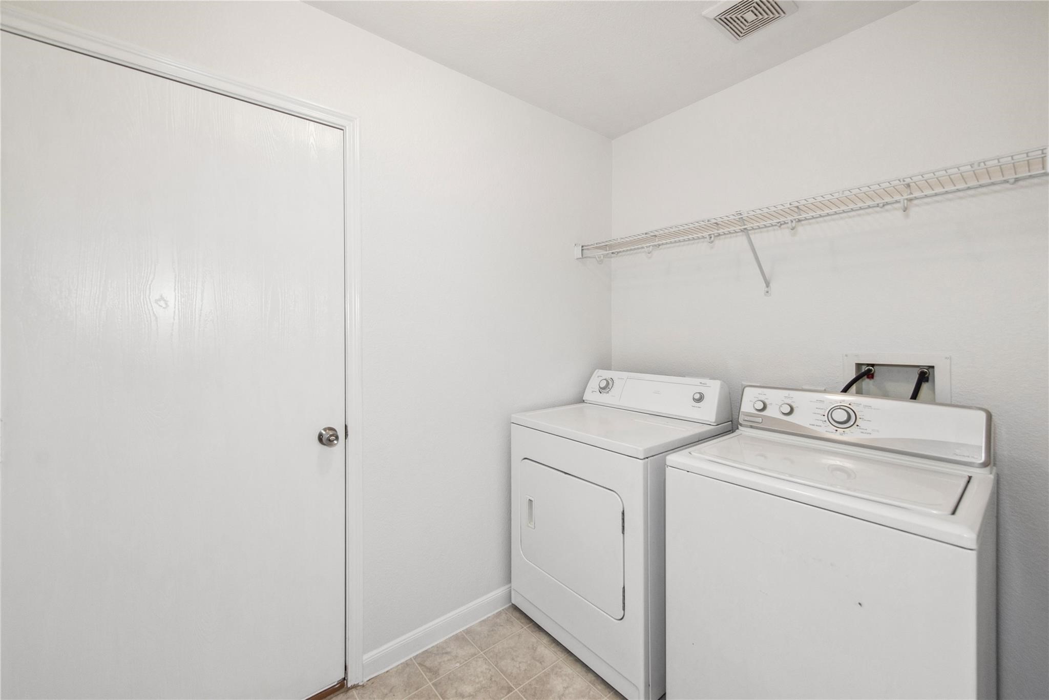 16310 Chandler Ridge Lane Cypress, TX 77429 - Photo 17 of 25 a utility room with dryer and washer