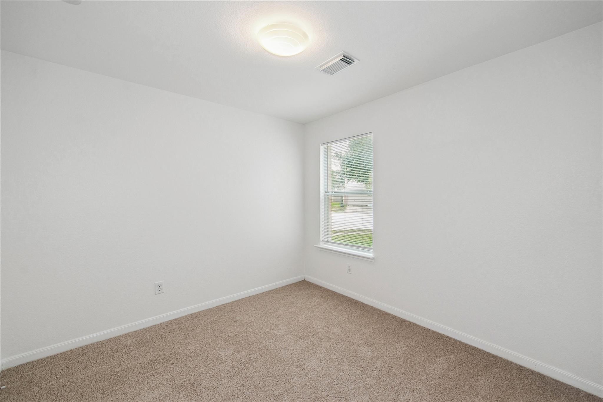 16310 Chandler Ridge Lane Cypress, TX 77429 - Photo 18 of 25 an empty room with a window