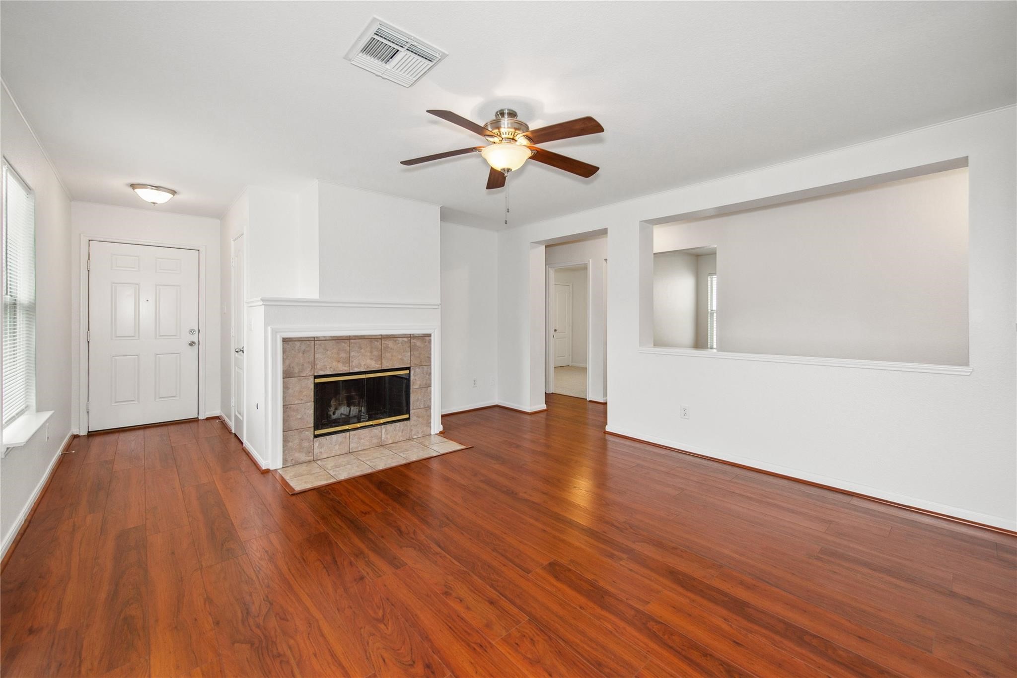 16310 Chandler Ridge Lane Cypress, TX 77429 - Photo 2 of 25 a view of empty room with wooden floor and fireplace