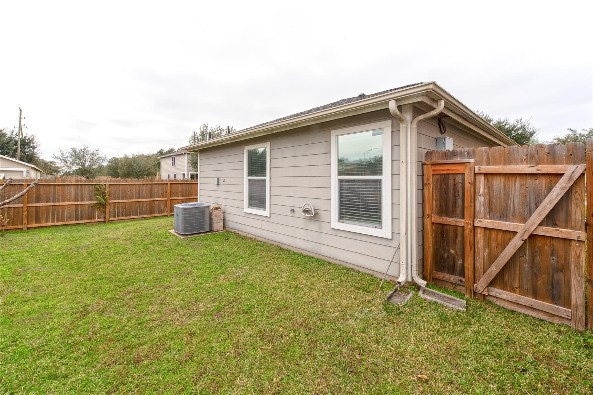 16310 Chandler Ridge Lane Cypress, TX 77429 - Photo 22 of 25 a backyard of a house with table and chairs