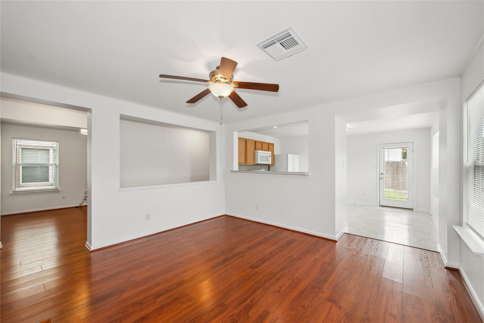 16310 Chandler Ridge Lane Cypress, TX 77429 - Photo 3 of 25 a view of a room with wooden floor and a ceiling fan