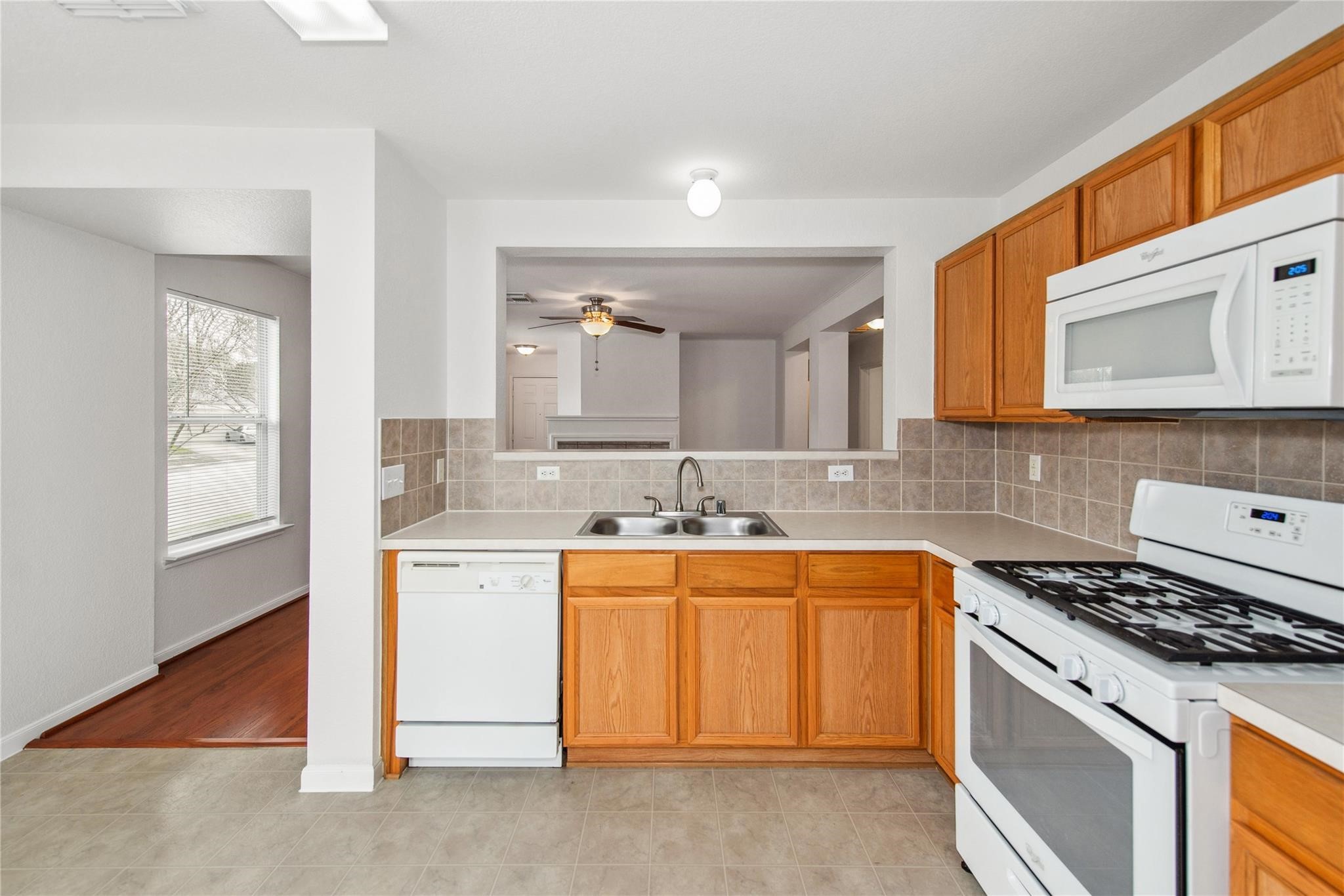 16310 Chandler Ridge Lane Cypress, TX 77429 - Photo 5 of 25 a kitchen with a sink stove and cabinets