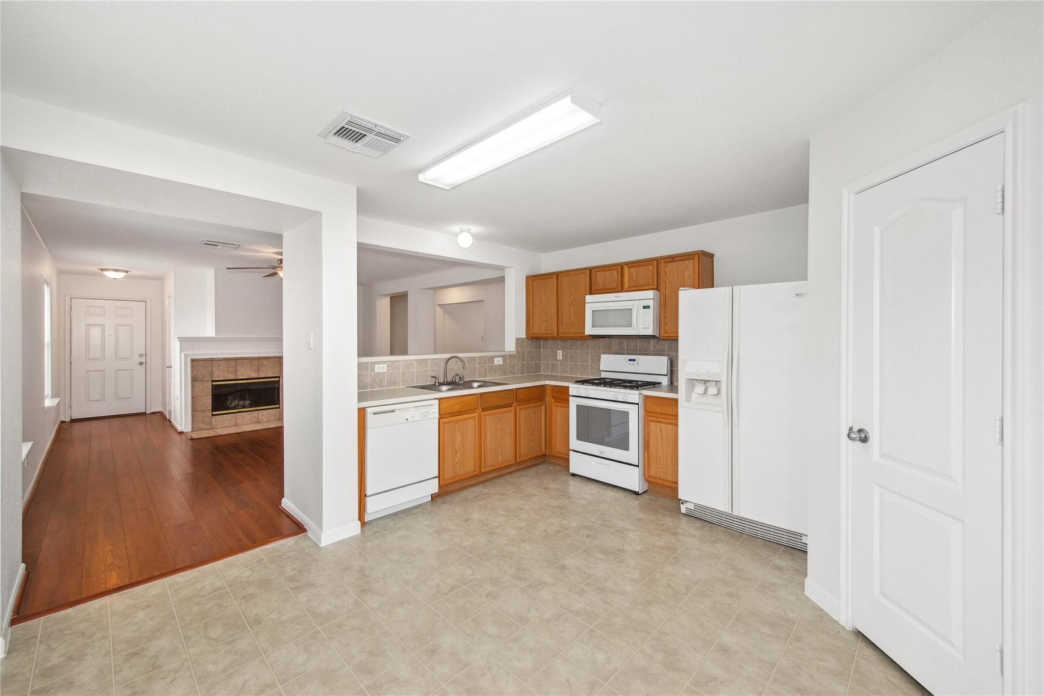 16310 Chandler Ridge Lane Cypress, TX 77429 - Photo 6 of 25 a large kitchen with stainless steel appliances granite countertop a stove and a refrigerator