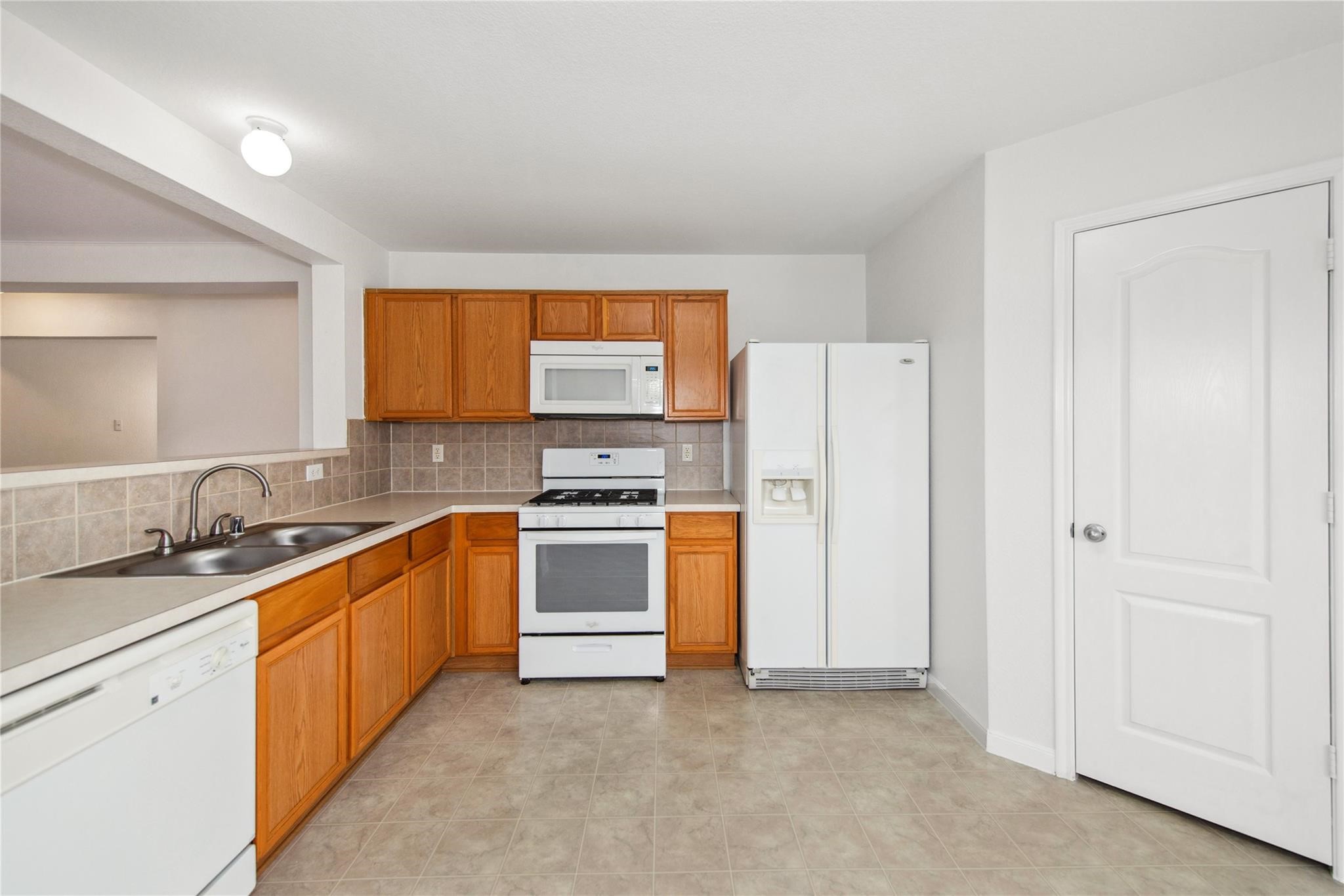 16310 Chandler Ridge Lane Cypress, TX 77429 - Photo 7 of 25 a kitchen with stainless steel appliances granite countertop a refrigerator sink and stove