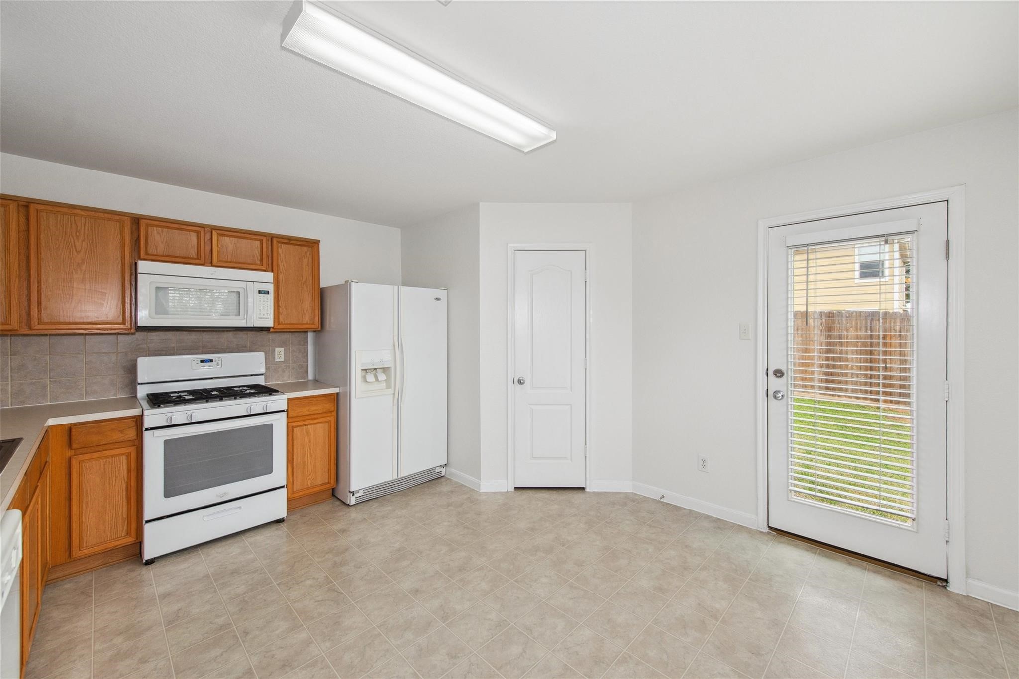 16310 Chandler Ridge Lane Cypress, TX 77429 - Photo 8 of 25 a kitchen with stainless steel appliances granite countertop a stove a sink and a refrigerator