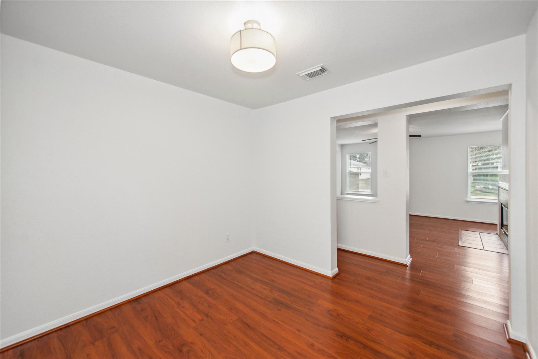 16310 Chandler Ridge Lane Cypress, TX 77429 - Photo 10 of 25 a view of an empty room with wooden floor and a window