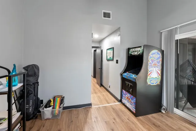 a view of a hallway with wooden floor and stairs