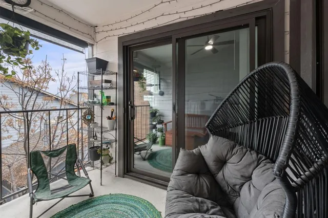 a balcony with furniture and a potted plant