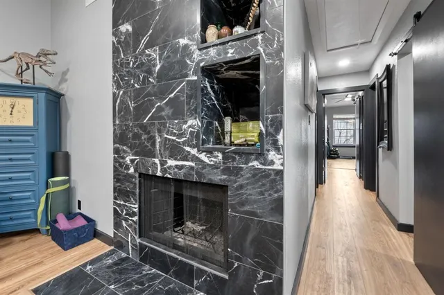 a hallway with fireplace and wooden floor