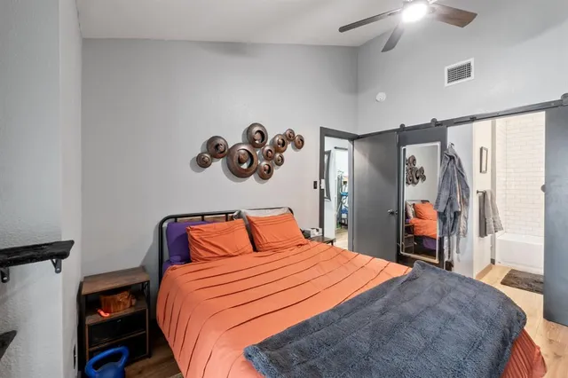 a bedroom with a bed and a chandelier