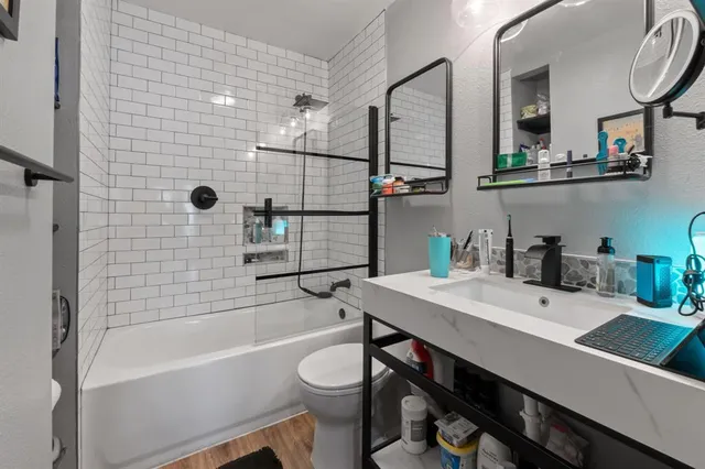 a bathroom with a sink a toilet and shower