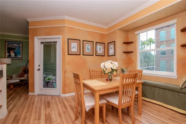 a view of a dining room with furniture window and wooden floor
