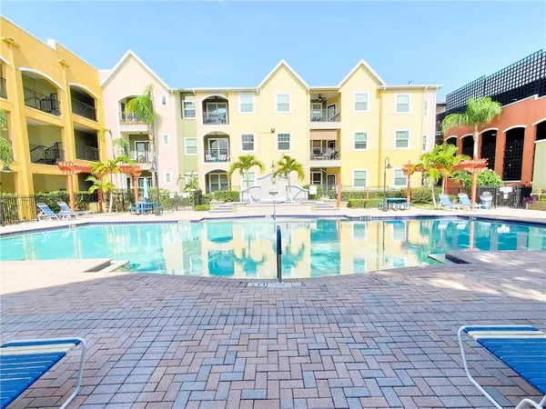 a view of swimming pool with outdoor seating and a pathway