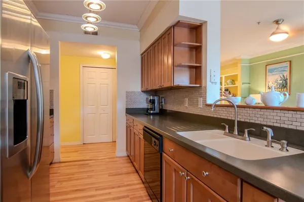 a kitchen with stainless steel appliances granite countertop a sink stove and refrigerator