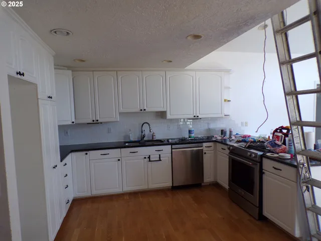 a kitchen with granite countertop a sink and cabinets