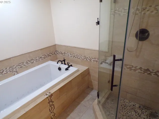 a bathroom with a bathtub and shower