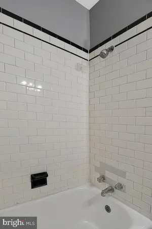 a bathroom with a shower and a sink