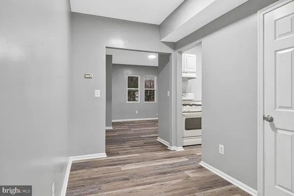 a view of a hallway with wooden floor and staircase