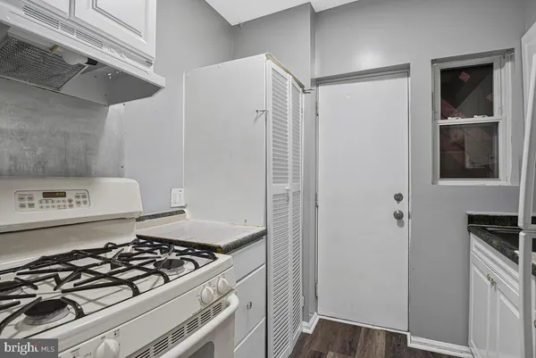 a kitchen with a stove and a refrigerator