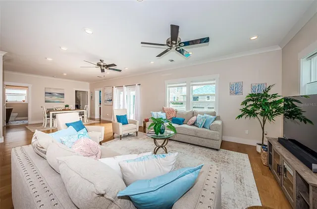 a living room with furniture and a potted plant