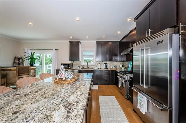 a kitchen with a refrigerator and a sink