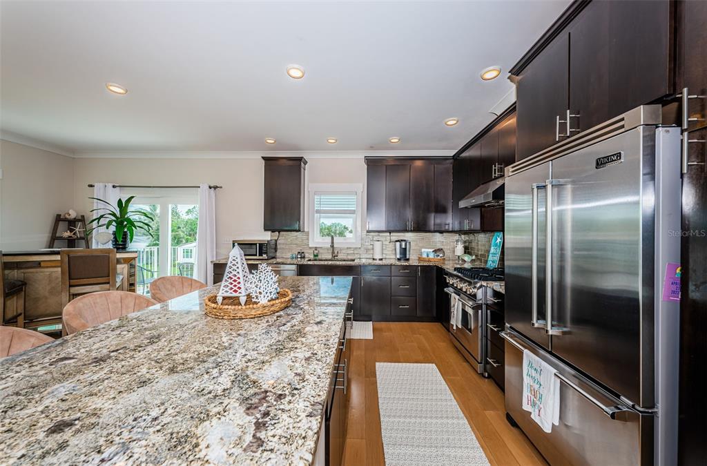 16109 3rd Street East Redington Beach, FL 33708 - Photo 4 of 25 a kitchen with a refrigerator and a sink