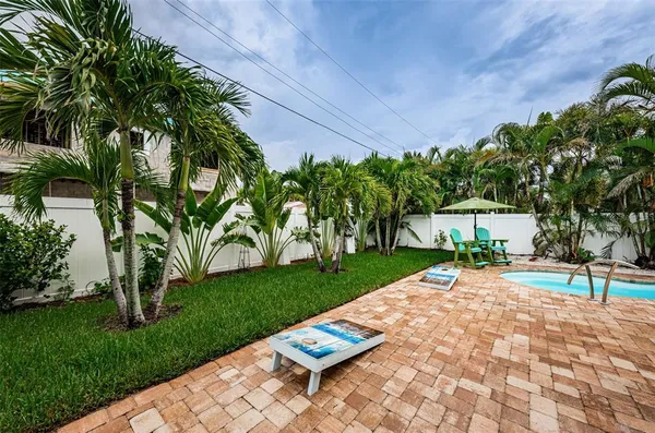 a backyard of a house with table and chairs
