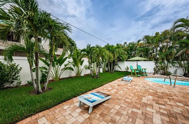 a backyard of a house with table and chairs