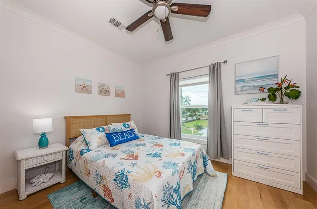 a bedroom with a bed a dresser and a window