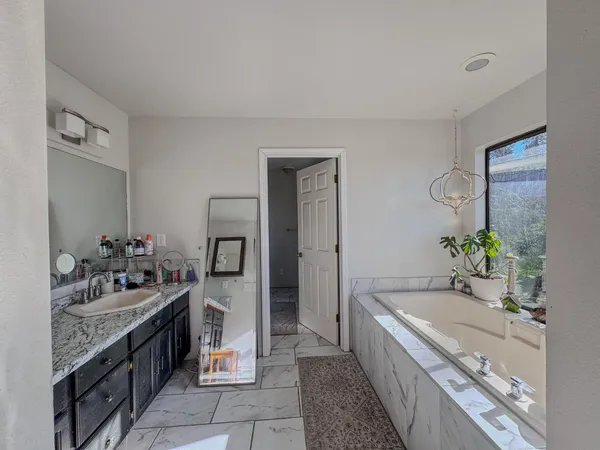 a bathroom with a sink mirror and toilet