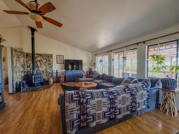 a living room with furniture and a floor to ceiling window