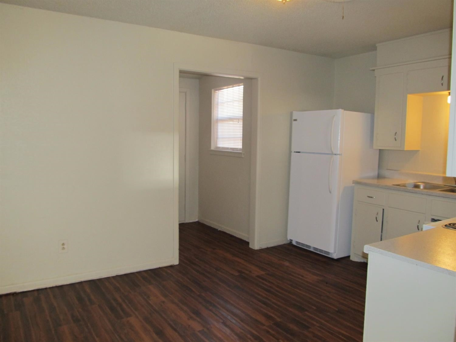 4516 35th Street, Unit B Lubbock, TX 79414 - Photo 3 of 7 a view of a room with wooden floor and a sink