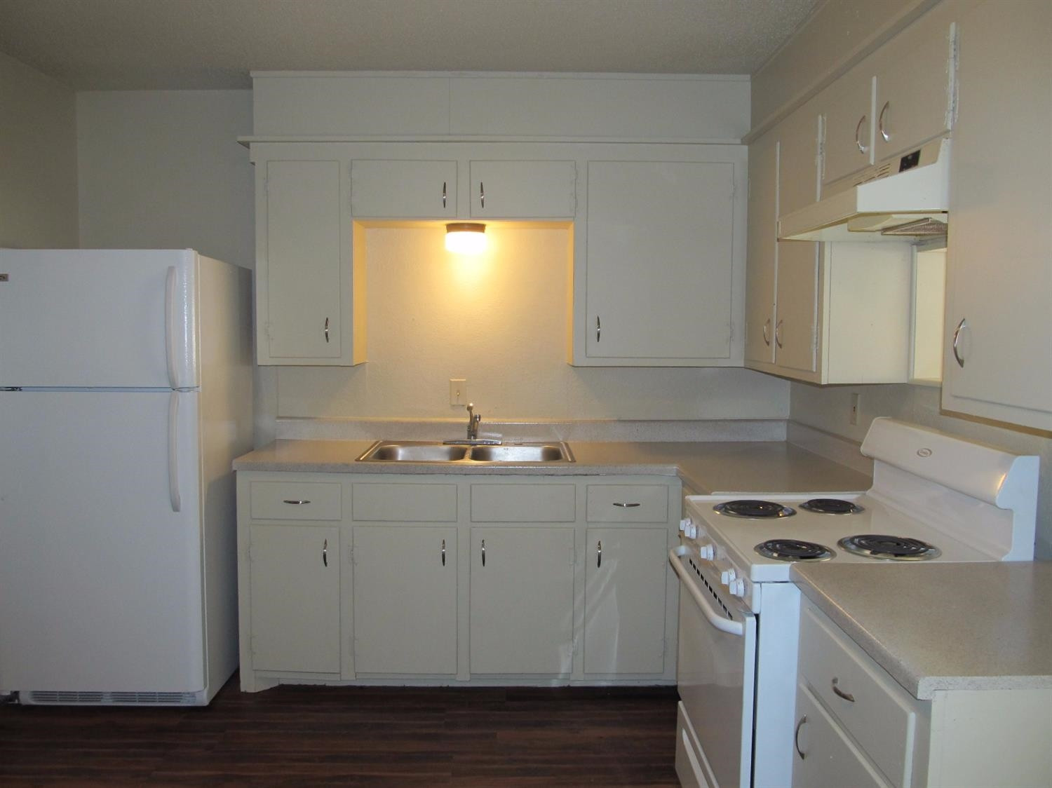 4516 35th Street, Unit B Lubbock, TX 79414 - Photo 4 of 7 a kitchen with a sink a refrigerator and a stove