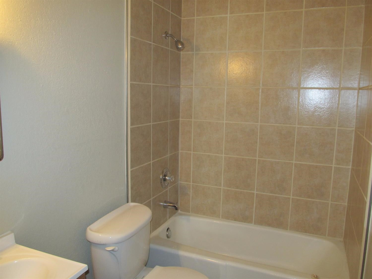 4516 35th Street, Unit B Lubbock, TX 79414 - Photo 7 of 7 a bath room with a toilet and a bath tub