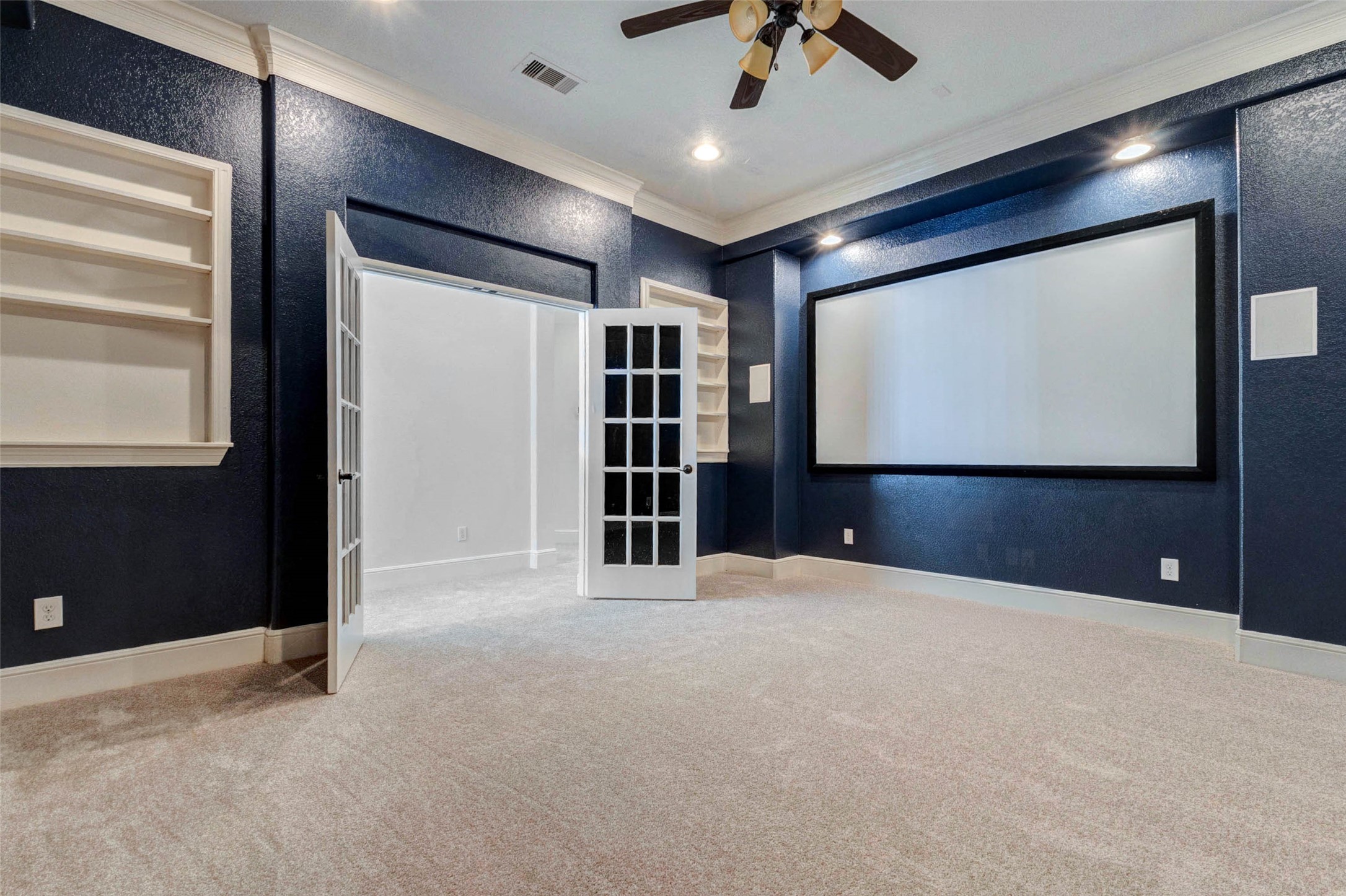 5327 Whitmore Fulshear, TX 77441 - Photo 29 of 50 Another view highlights the media room's generous dimensions and ready-to-enjoy setup, making it a true entertainment retreat.