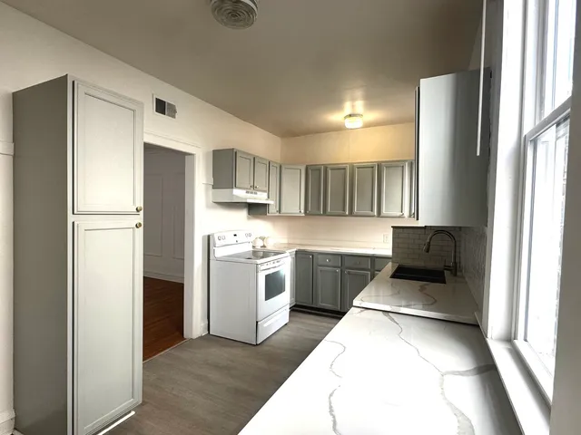 a kitchen with a refrigerator sink and stove
