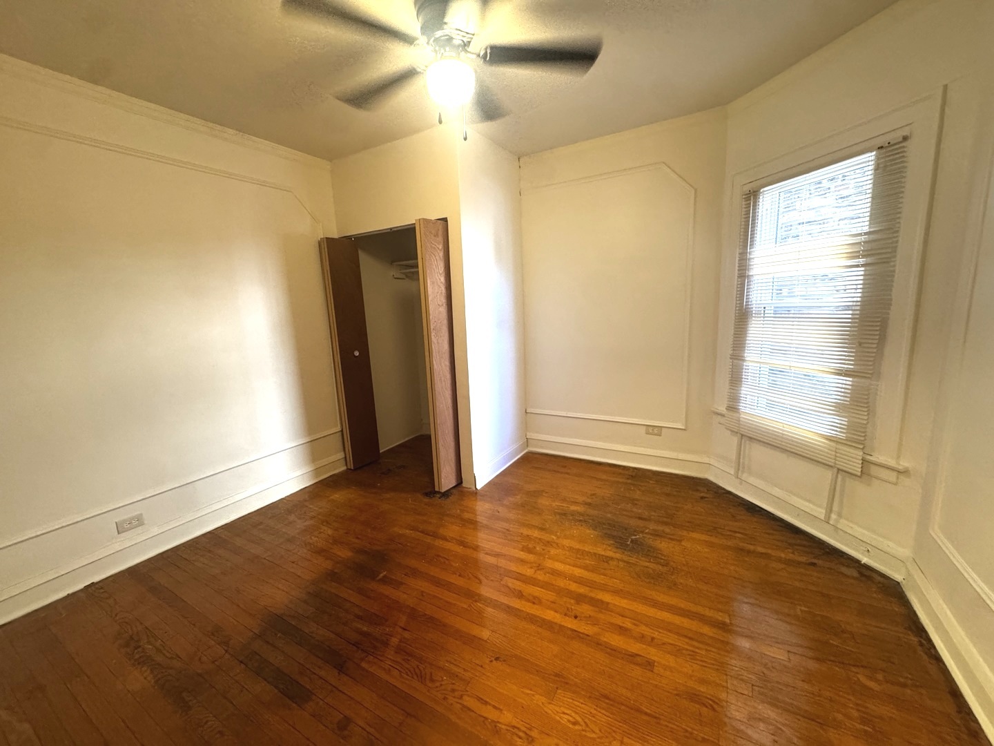 6937 South Merrill Avenue Chicago, IL 60649 - Photo 7 of 15 a view of an empty room with wooden floor and a window