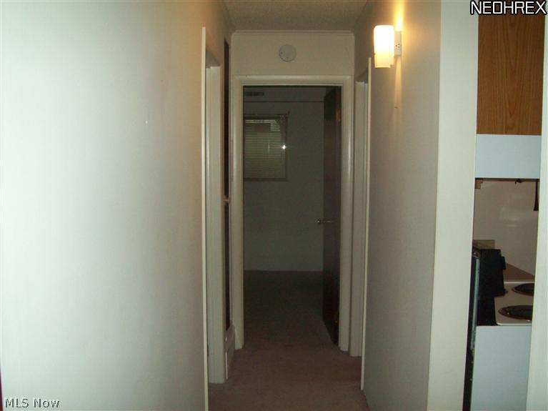 9956 Johnnycake Ridge Road, Unit L3 Painesville, OH 44077 - Photo 10 of 15 Looking down the hall from the living room. Bedroom 2 is on the left, bedroom 1 is at the end, the restroom is the 2nd door on the right, and the kitchen is the first door to the right.